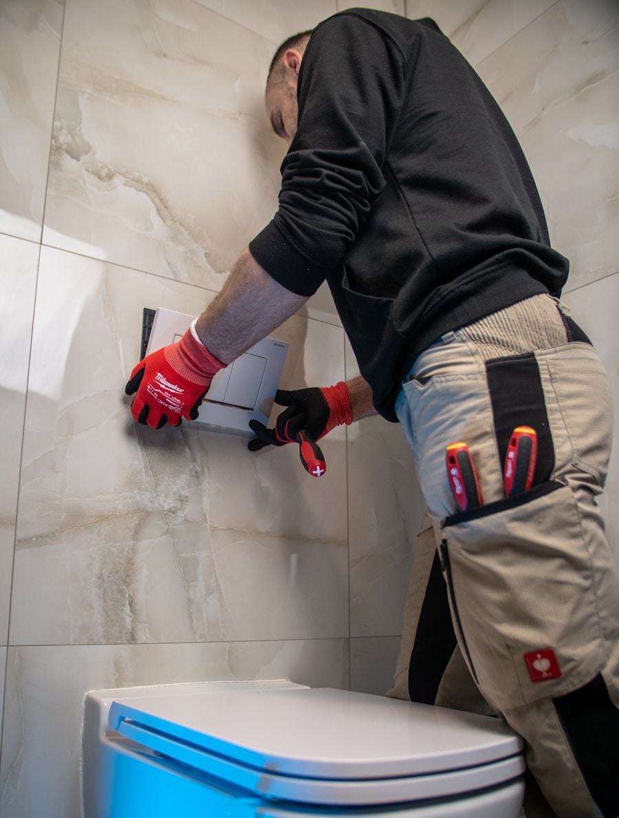 Plumber in gloves servicing a toilet